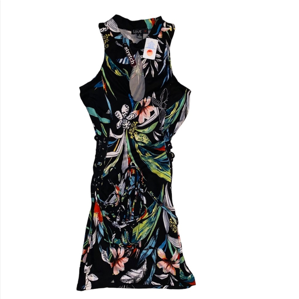 Beautiful tight fitting dress adjustable with string on each side, size small.